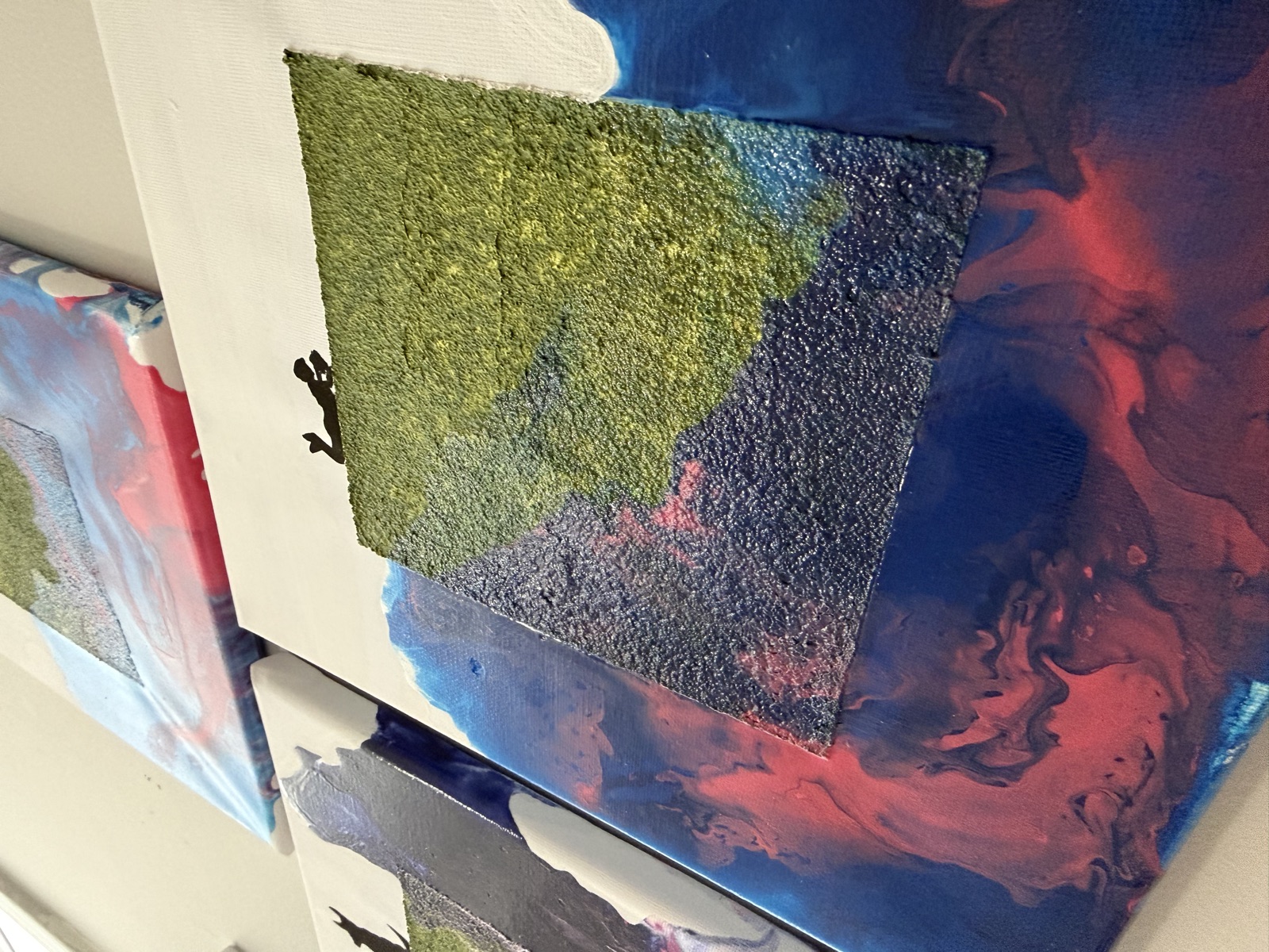 The three silhouette-series canvases displayed together